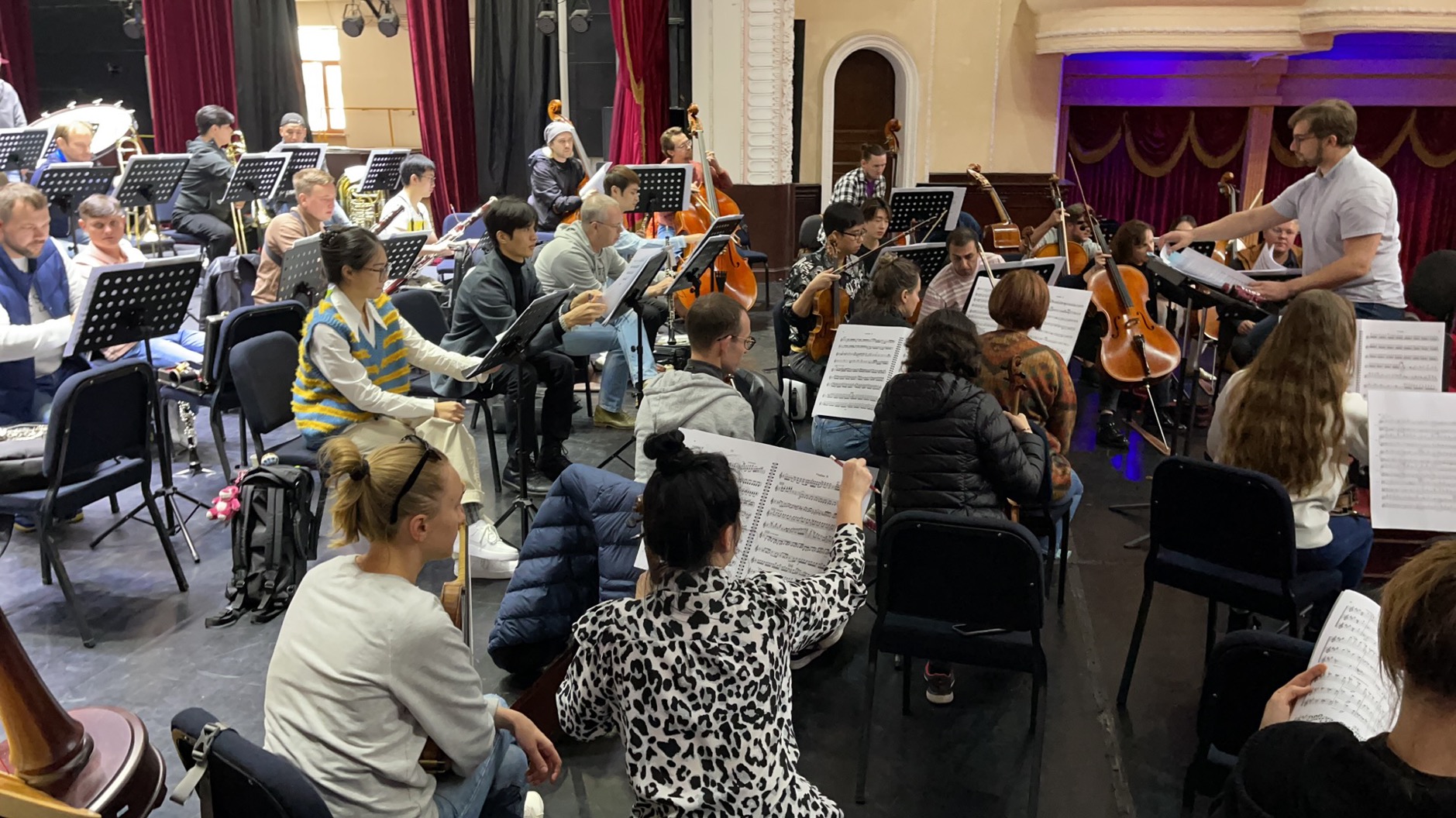 Conductor Oleg Sheremeta rehearsing with orchestra